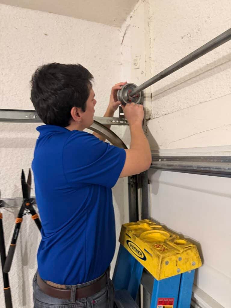 an image of ken the owner of lightning fast garage door repair performing garage door maintenance
