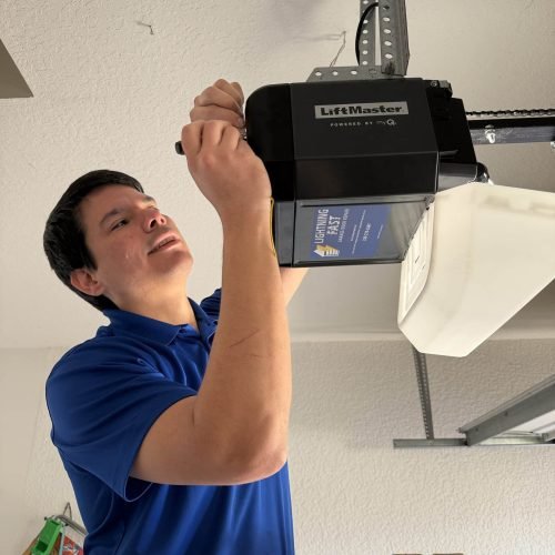 an image of ken the owner of lightning fast garage door repair servicing an opener